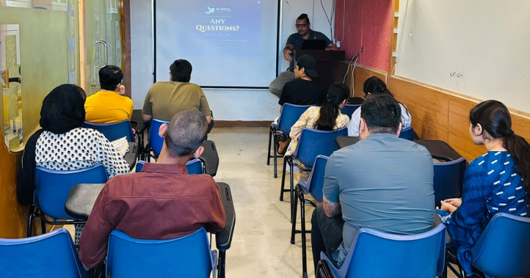 Sam presenting an AI seminar to a hall of students at Burraq Academy